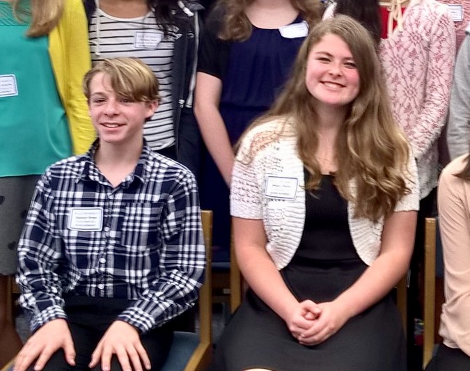Boy and girl student from Cruickshank sitting at ceremony